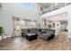 Open-concept living room featuring wood-look floors, a large sectional, and bright windows at 6621 S Balboa Dr, Gilbert, AZ 85298