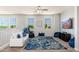 Spacious upstairs living room with a comfortable white sofa, blue accents, and large windows at 6621 S Balboa Dr, Gilbert, AZ 85298