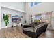 Bright living room with tall ceilings, a large sectional, and wood-look floors at 6621 S Balboa Dr, Gilbert, AZ 85298