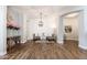 Elegant living room with wood-look floors, accent wall, and stylish furnishings at 6621 S Balboa Dr, Gilbert, AZ 85298