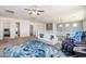 Upstairs loft area featuring a modern sofa, decor, and open access to other rooms at 6621 S Balboa Dr, Gilbert, AZ 85298