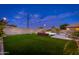 Backyard oasis featuring a swimming pool, putting green, and outdoor dining space for entertaining at 6621 S Balboa Dr, Gilbert, AZ 85298