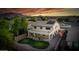 An aerial view reveals a well-maintained backyard with a unique kidney-shaped lawn and covered patio at 6623 S Classic Way, Gilbert, AZ 85298