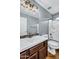 Well-lit bathroom featuring a dark wood vanity, white countertop, and tiled backsplash at 6623 S Classic Way, Gilbert, AZ 85298