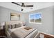 Comfortable bedroom with a neutral color palette, ceiling fan, and ample natural light at 6623 S Classic Way, Gilbert, AZ 85298