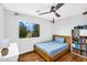 Bright bedroom with a comfortable bed, laminate wood floor, and playful decorations at 6623 S Classic Way, Gilbert, AZ 85298