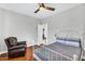 Bedroom featuring a white metal bed frame and an armchair with a hardwood floor at 6623 S Classic Way, Gilbert, AZ 85298