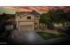 An exterior of a two story home with a well-kept lawn and mature landscaping in a suburban setting at 6623 S Classic Way, Gilbert, AZ 85298