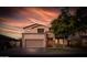 Home exterior featuring a two-car garage, neutral paint, and a well-maintained lawn at 6623 S Classic Way, Gilbert, AZ 85298