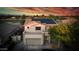 Two-story house with solar panels, tile roof, neutral stucco, and a two-car garage at 6623 S Classic Way, Gilbert, AZ 85298