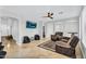 Spacious living room with tiled floors, comfortable seating, and ceiling fan at 6623 S Classic Way, Gilbert, AZ 85298