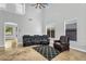 A spacious living room boasting a high ceiling, ample natural light, and comfortable leather seating at 6623 S Classic Way, Gilbert, AZ 85298