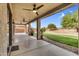 Spacious covered patio with ceiling fans overlooking the manicured backyard at 6623 S Classic Way, Gilbert, AZ 85298