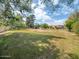 Expansive backyard with green grass, mature trees, and a view of the house and outdoor structures at 6735 E San Juan Ave, Paradise Valley, AZ 85253