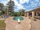 Backyard pool with surrounding patio and lounge chairs, set against a lush, green landscape at 6735 E San Juan Ave, Paradise Valley, AZ 85253