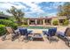 Backyard pool with lounge chairs and fire pit, surrounded by lush landscaping at 6735 E San Juan Ave, Paradise Valley, AZ 85253