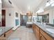 Well-lit bathroom with double sinks, granite countertops, soaking tub, glass shower, and tile floors at 6735 E San Juan Ave, Paradise Valley, AZ 85253