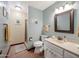 Traditional bathroom with light blue walls featuring a vanity, toilet, and a walk-in shower at 6735 E San Juan Ave, Paradise Valley, AZ 85253