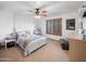 Bright bedroom featuring a bed, closet, shuttered window, ceiling fan, dresser and makeup vanity at 6735 E San Juan Ave, Paradise Valley, AZ 85253