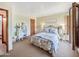 Comfortable bedroom with carpet, natural light, closet and furnishings including bed, dresser, mirror and lamps at 6735 E San Juan Ave, Paradise Valley, AZ 85253