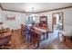 Dining room with hardwood floors, wooden table, seating for six, chandelier and access to living room at 6735 E San Juan Ave, Paradise Valley, AZ 85253
