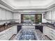 Updated kitchen with granite counters, white cabinets and gas cooktop, view of pool in backyard at 6735 E San Juan Ave, Paradise Valley, AZ 85253