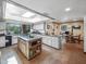 Bright kitchen with granite countertops, a center island cooktop, tile flooring and a window overlooking the yard at 6735 E San Juan Ave, Paradise Valley, AZ 85253