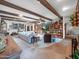 Spacious living room with beamed ceilings, stone floors, and ample natural light at 6735 E San Juan Ave, Paradise Valley, AZ 85253