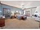 Spacious main bedroom with a fireplace, carpeted floors, ceiling fan and backyard access through french doors at 6735 E San Juan Ave, Paradise Valley, AZ 85253