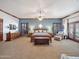 Large main bedroom featuring ceiling fan, carpet, shuttered windows, and french door access to backyard at 6735 E San Juan Ave, Paradise Valley, AZ 85253