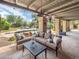 Covered patio with outdoor seating area, stone flooring, and views of the backyard pool at 6735 E San Juan Ave, Paradise Valley, AZ 85253