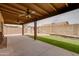 Inviting backyard space with a covered patio, artificial turf, and a storage shed at 7402 W Corrine Dr, Peoria, AZ 85381