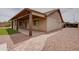 Well-kept backyard showcases a covered patio, desert landscaping, and small patch of artificial turf at 7402 W Corrine Dr, Peoria, AZ 85381