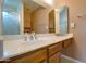 Bathroom featuring vanity with sink, mirror, and a shower with glass door at 7402 W Corrine Dr, Peoria, AZ 85381