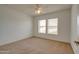 Bedroom with neutral carpet, ceiling fan, and windows providing natural light at 7402 W Corrine Dr, Peoria, AZ 85381