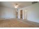 Bright bedroom with neutral carpet, ceiling fan, closet and ensuite bathroom at 7402 W Corrine Dr, Peoria, AZ 85381