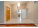 Open foyer with tiled floors and decorative lighting features a glimpse of the kitchen at 7402 W Corrine Dr, Peoria, AZ 85381