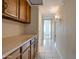 Hallway features tile flooring, wood cabinets and countertop with a view into a bedroom at 7402 W Corrine Dr, Peoria, AZ 85381