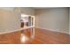 Open living room space with hardwood floors, high ceilings and view into the kitchen at 7402 W Corrine Dr, Peoria, AZ 85381