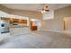 Open living space with a ceiling fan, carpet flooring, and views of kitchen and dining area at 7402 W Corrine Dr, Peoria, AZ 85381