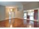 Open concept floor plan with hardwood floors, a view of the kitchen and elegant light fixtures at 7402 W Corrine Dr, Peoria, AZ 85381