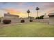 Spacious backyard with lush lawn, privacy fence, and palm trees at 7624 E Plata Ave, Mesa, AZ 85212