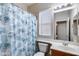 Bathroom with patterned shower curtain, tile flooring, window and single sink at 7624 E Plata Ave, Mesa, AZ 85212
