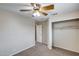 Bedroom with carpet flooring, ceiling fan, and spacious closet at 7624 E Plata Ave, Mesa, AZ 85212