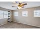 Bedroom with neutral carpet, ceiling fan, and three bright windows at 7624 E Plata Ave, Mesa, AZ 85212