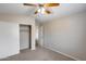 Neutral bedroom with carpet, ceiling fan, closet, and white trim at 7624 E Plata Ave, Mesa, AZ 85212