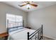 Cozy bedroom with patterned bedspread, iron bed frame, two side tables, and window at 7624 E Plata Ave, Mesa, AZ 85212
