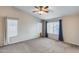 Large bedroom with vaulted ceiling, carpet, multiple windows, neutral walls, and a ceiling fan at 7624 E Plata Ave, Mesa, AZ 85212