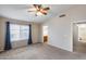 Large bedroom with vaulted ceiling, carpet, window, neutral walls, and a ceiling fan at 7624 E Plata Ave, Mesa, AZ 85212