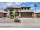 Two-story home featuring desert landscaping, a two-car garage, and solar panels at 7624 E Plata Ave, Mesa, AZ 85212